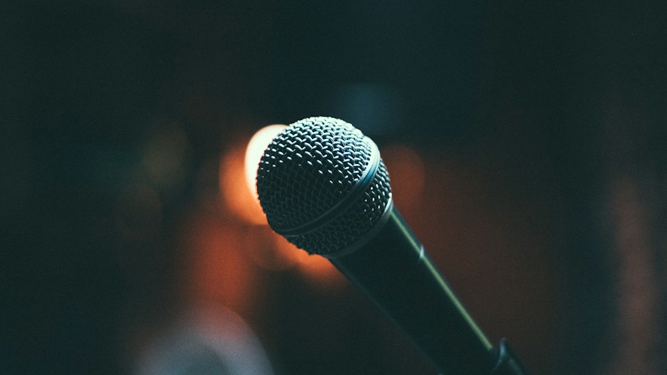A microphone ready for a comedy conversation on stage